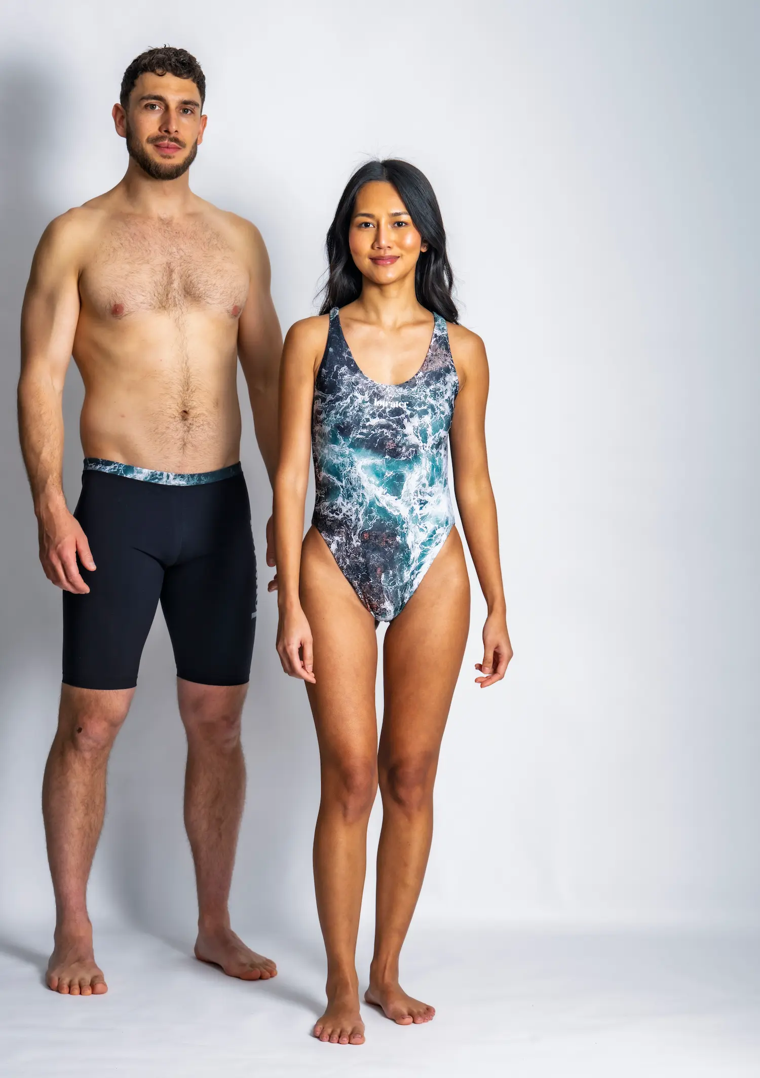 A man and a woman wearing green pacific waves